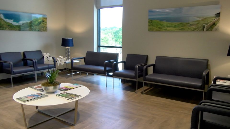 Interior of office with chairs and benches-waiting area at {PRACTICE_NAME}