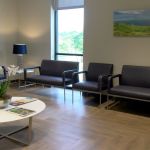 Interior of office with chairs and benches-waiting area at {PRACTICE_NAME}
